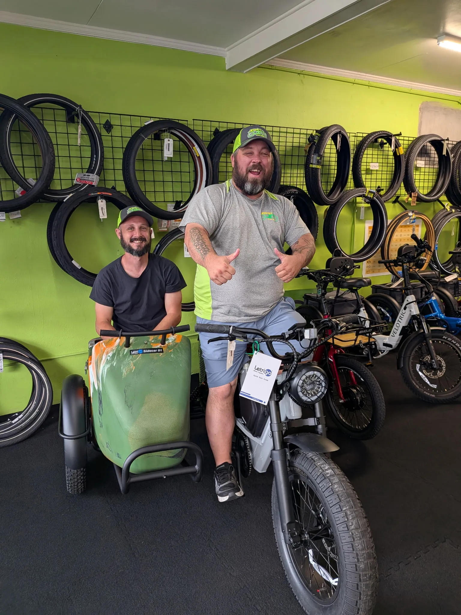 Two of Sparky's crew in the shop with a Letrigo sidecar bike