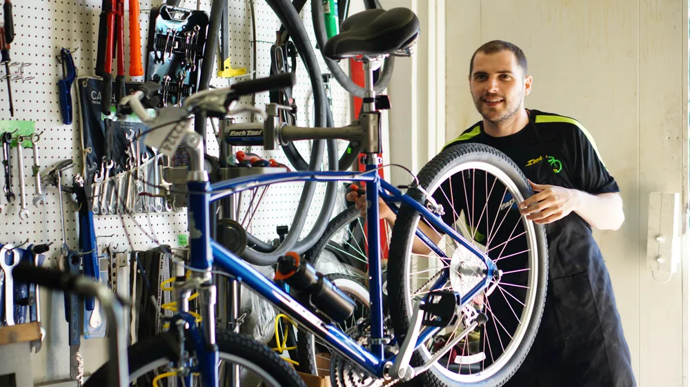 A Sparky's mechanic installing a wheel in the service shop